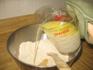 adding water and butter to flour